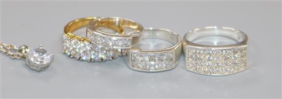 Three silver and cubic zirconia rings, a similar gold-plated ring and a similar pendant on chain